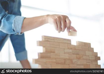 Woman holding blocks wood game - Building and risk concept