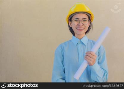 Woman holding Blueprint Helmet hard hat Foreman Building construction estate development concept