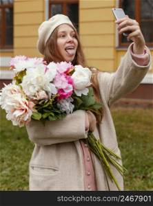 woman holding bouquet flowers outdoors spring taking selfie