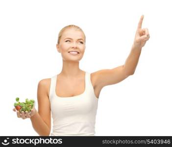 woman holding bowl with salad and ponting her finger
