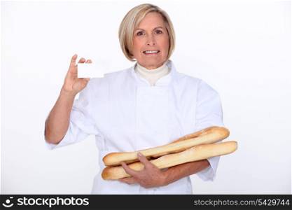 woman holding bread and showing her personnal card