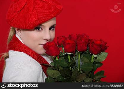 Woman holding bunch of red roses