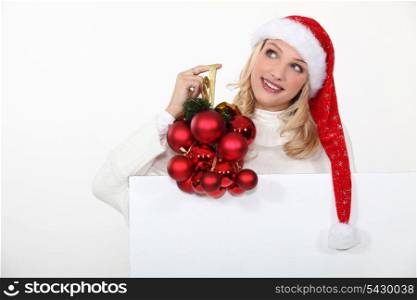 Woman holding Christmas ornaments