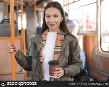 woman holding coffee public tram transport