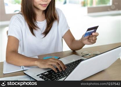 Woman holding credit card and tying, account and saving concept