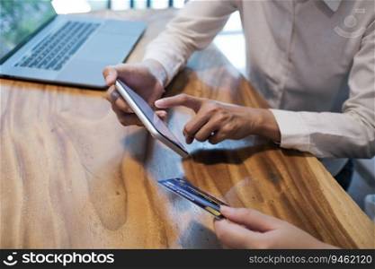 Woman holding credit card and using laptop computer. Online shopping concept