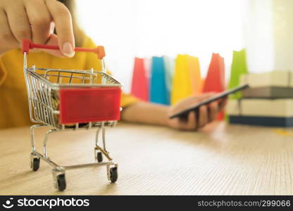 Woman holding credit card and using smartphone for shopping online