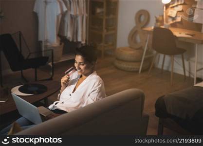 woman holding credit card working home