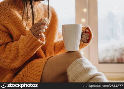 woman holding cup tea indoors