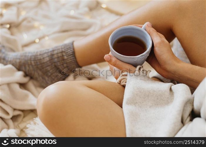 woman holding cup tea while enjoying winter holidays 2