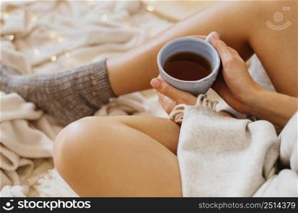woman holding cup tea while enjoying winter holidays 2