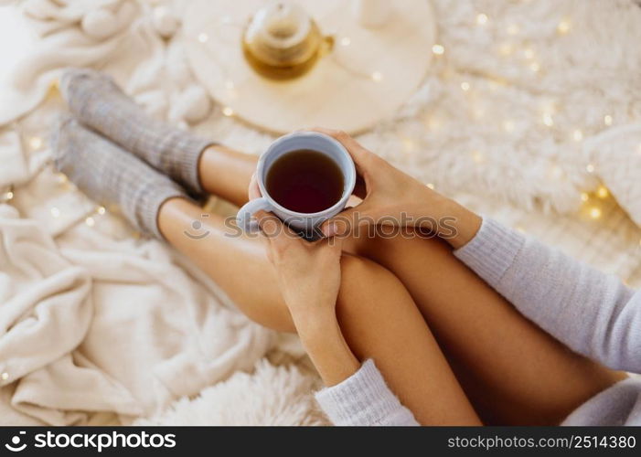 woman holding cup tea while enjoying winter holidays