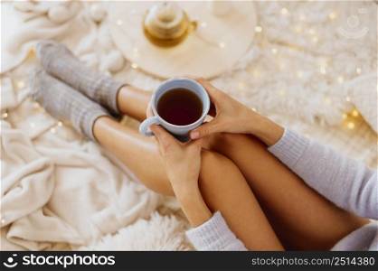 woman holding cup tea while enjoying winter holidays
