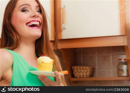 Woman holding delicious cake with sweet cream and fruits on top. Appetite and gluttony concept.. Woman holding delicious sweet cake. Gluttony.
