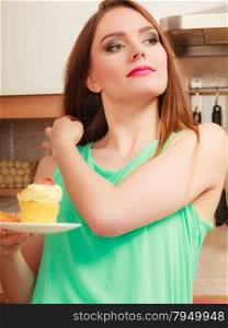 Woman holding delicious cake with sweet cream and fruits on top. Appetite and gluttony concept.. Woman holding delicious sweet cake. Gluttony.