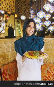 woman holding dish arab food