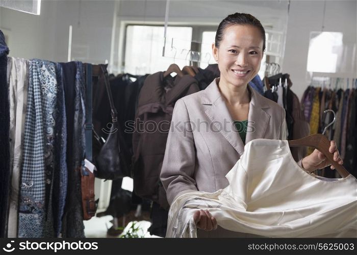 Woman holding dress at fashion store
