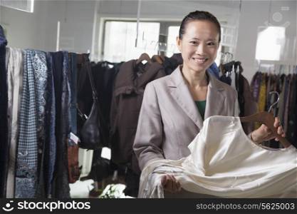 Woman holding dress at fashion store