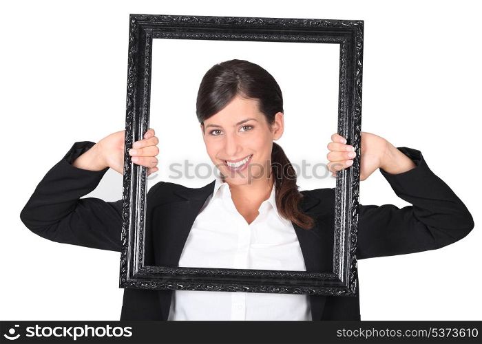 Woman holding empty art frame