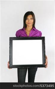 Woman holding empty frame