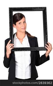 Woman holding empty picture frame