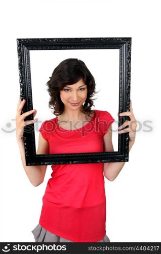 Woman holding empty picture frame