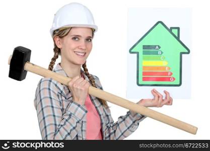 Woman holding energy rating information and sledge-hammer