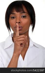 Woman holding finger to lips