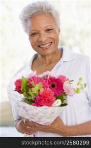 Woman holding flowers and smiling