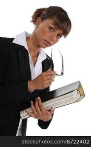 Woman holding folder full of paperwork
