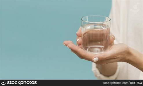 woman holding glass filled with water copy space. Resolution and high quality beautiful photo. woman holding glass filled with water copy space. High quality and resolution beautiful photo concept