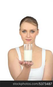Woman holding glass of milk