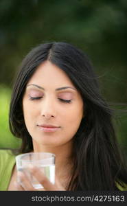 Woman holding glass of water