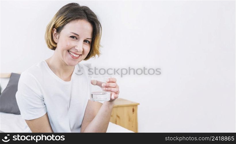 woman holding glass water