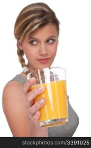 Woman holding glass with orange juice on white background, focus on hand