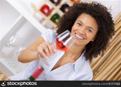 woman holding glass with rose wine