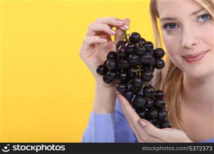 Woman holding grapes
