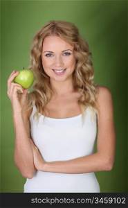 Woman holding green apple on green background