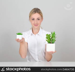 Woman holding green plant on white background