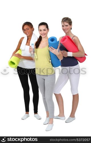 Woman holding gym mats