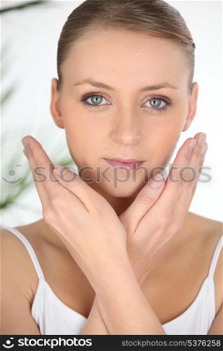 Woman holding hands to face