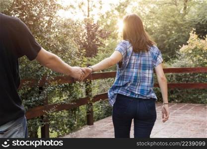 woman holding hands with man terrace forest