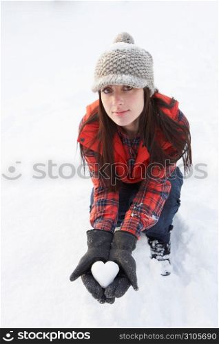 Woman Holding Heart Made Out Of Snow
