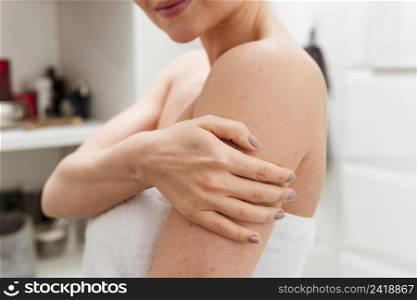 woman holding her arm bathroom