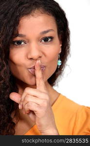 Woman holding her finger to her lips