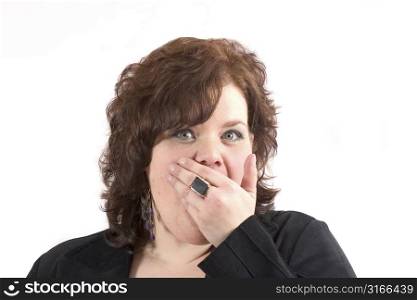 Woman holding her hand in front of her face with a shocked look