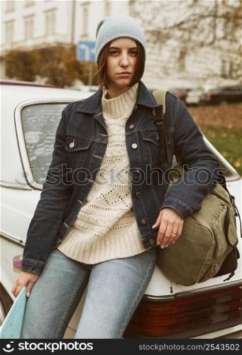 woman holding her skateboard while sitting car 2
