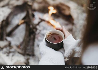 woman holding hot cup tea