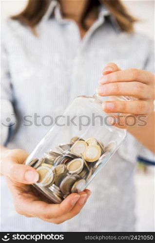 woman holding jar with money