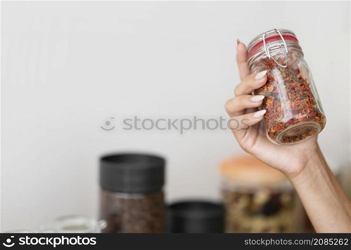 woman holding jar with spices with copy space